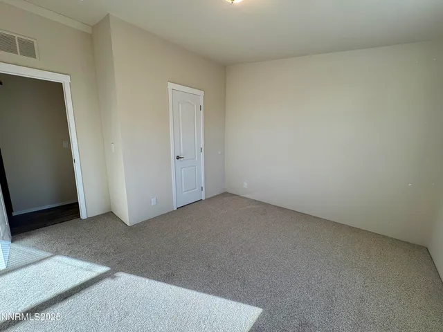 a view of an empty room and entryway