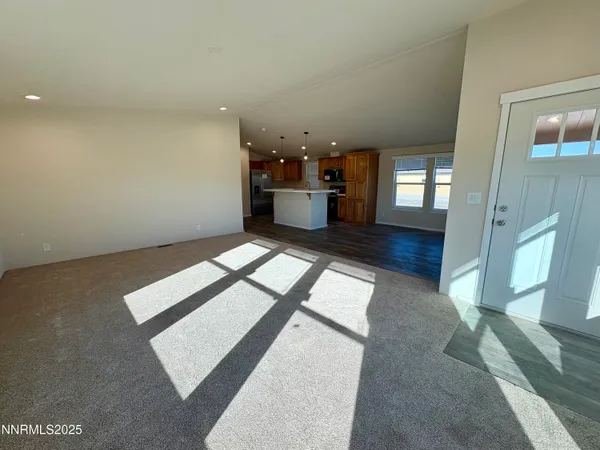 a view of a hallway with wooden floor and a couch