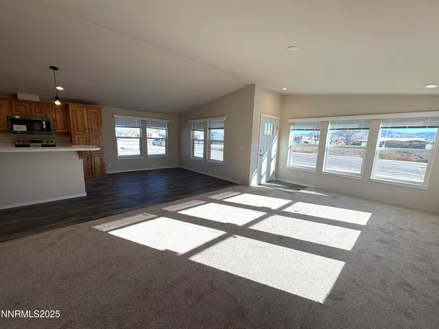 a living room with hardwood floor and windows