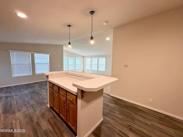 a kitchen that has a sink a stove and wooden floor