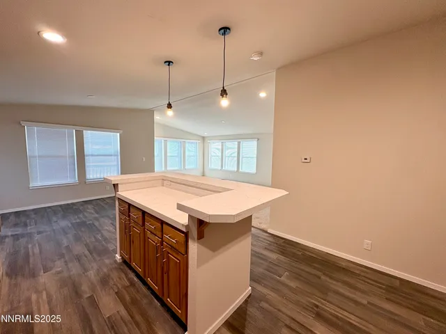 a kitchen that has a sink a stove and wooden floor