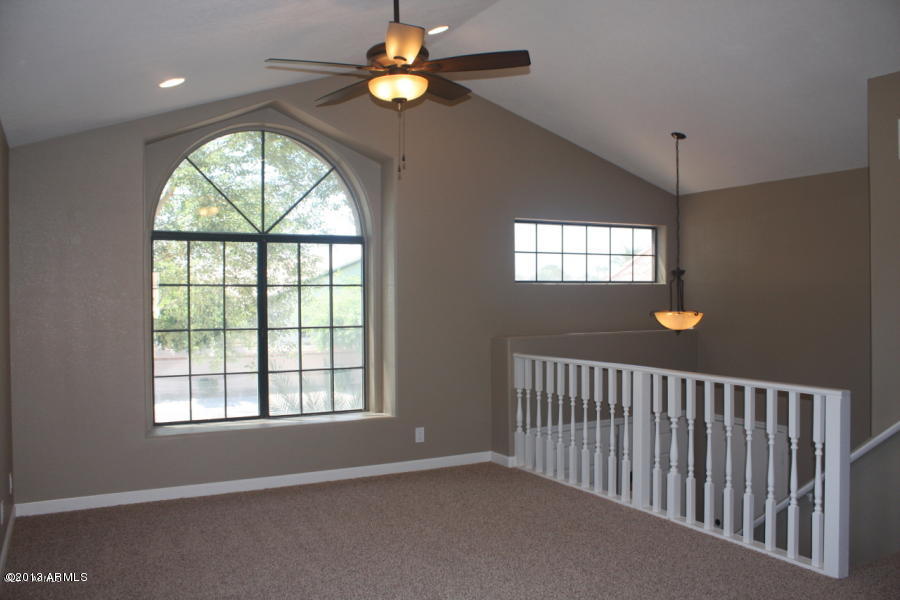 1522 West Del Rio Street Chandler, AZ 85224 - Photo 11 of 11 an empty room with windows and a chandelier fan