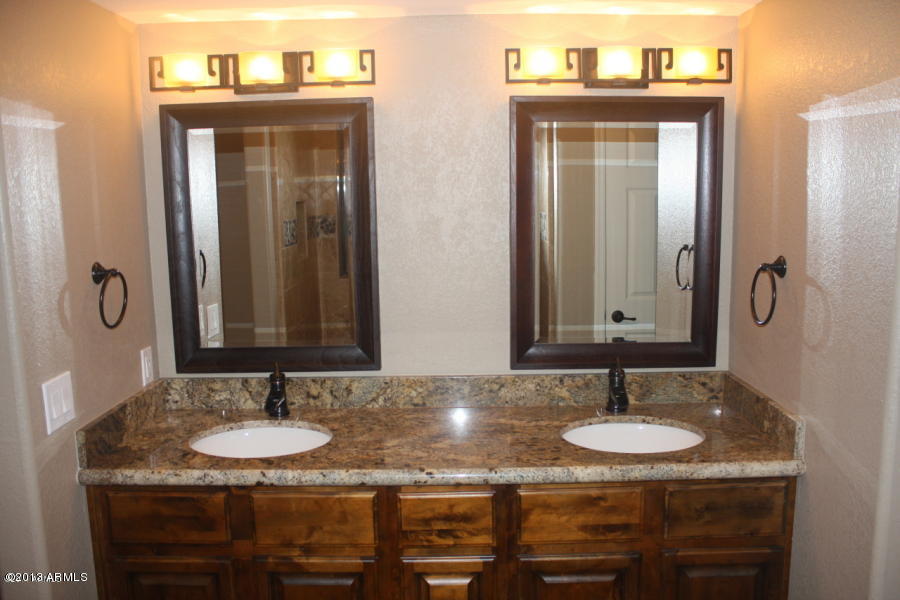 1522 West Del Rio Street Chandler, AZ 85224 - Photo 6 of 11 a bathroom with a granite countertop sink and a mirror