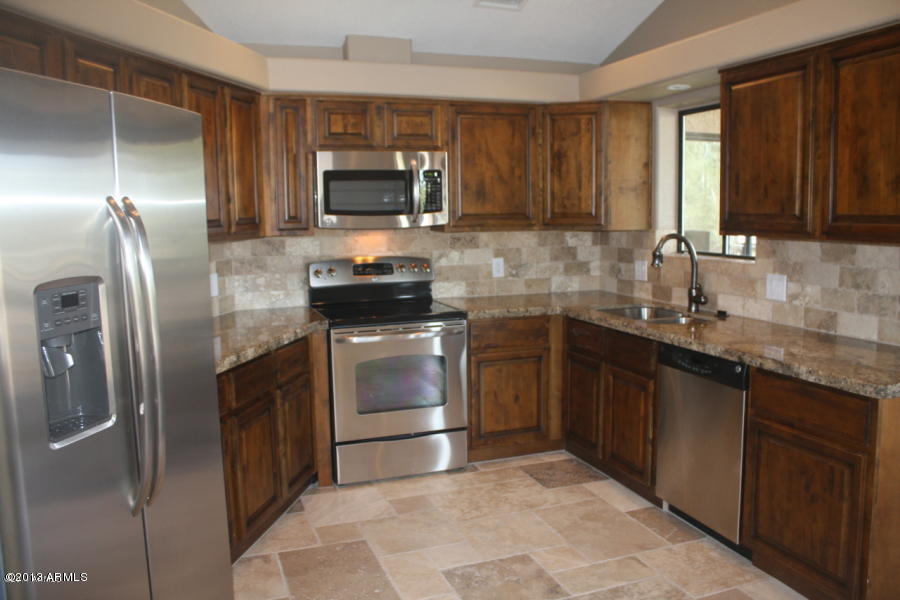 1522 West Del Rio Street Chandler, AZ 85224 - Photo 9 of 11 a kitchen with a sink stove and refrigerator