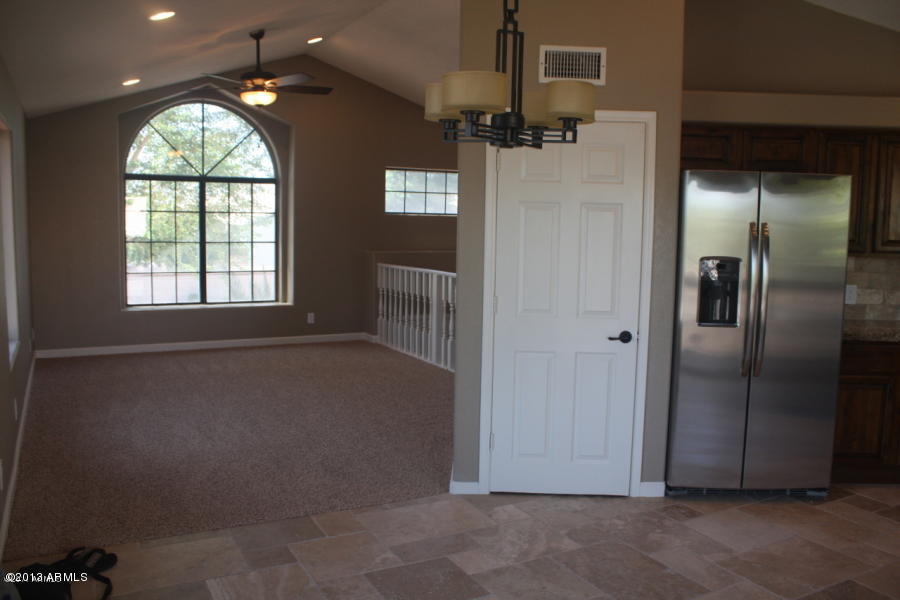 1522 West Del Rio Street Chandler, AZ 85224 - Photo 10 of 11 an empty room with a window and a chandelier