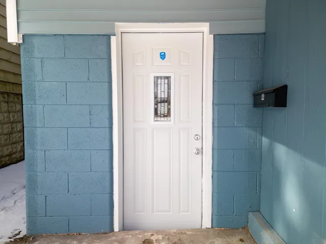a view of a hallway with wooden floor and closet
