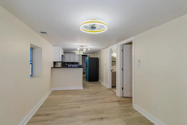 a kitchen with kitchen island a counter top space a stove and cabinets