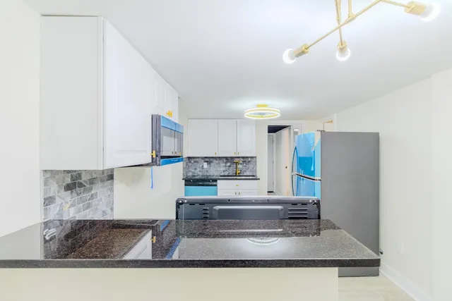 a kitchen with a refrigerator and a sink