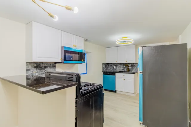 a kitchen with a stove and a microwave