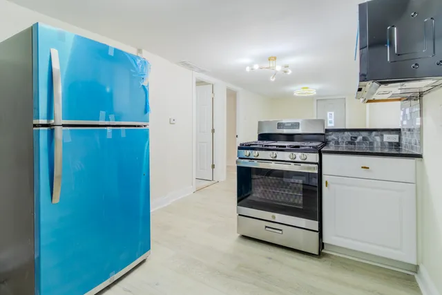 a kitchen with a stove a sink and a microwave