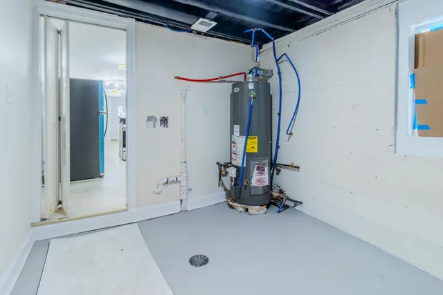 a view of a kitchen with a sink and a refrigerator