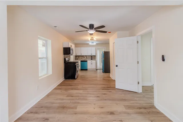 a kitchen with a stove top oven a refrigerator and a microwave