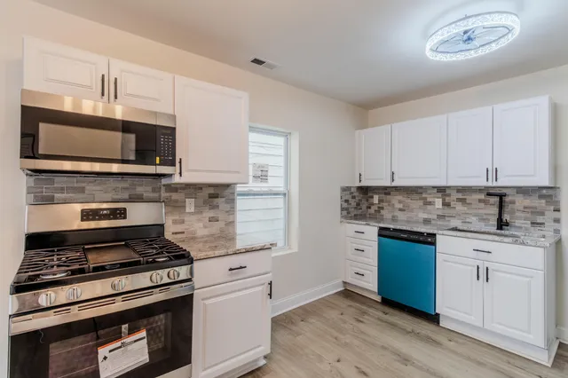 a kitchen with a refrigerator and a stove