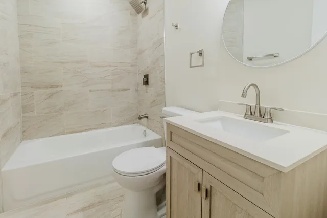 a bathroom with a sink mirror and toilet