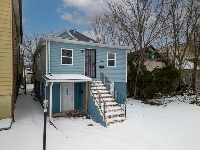 a front view of a house with yard and parking space