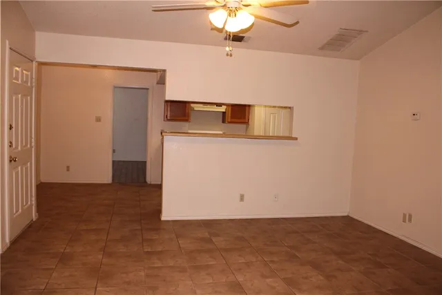 a view of a utility room with a ceiling fan