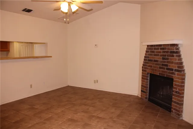 a view of empty room with a fireplace