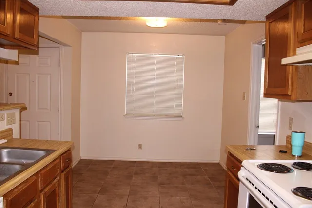 a kitchen that has a sink and a stove