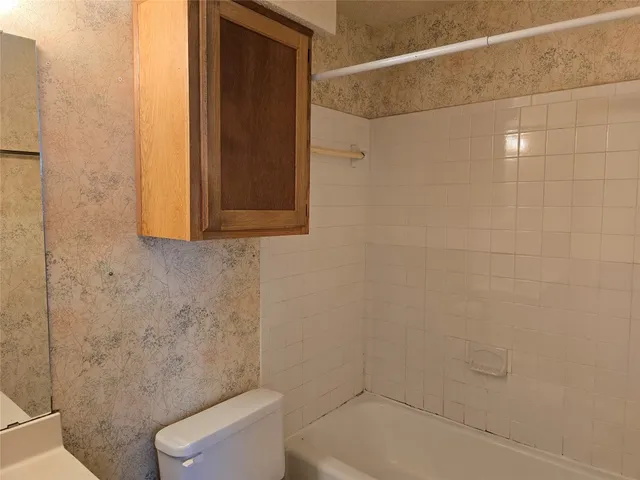 a bathroom with a toilet and shower