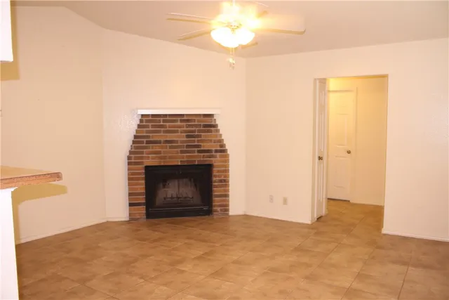 a view of an empty room with a fireplace