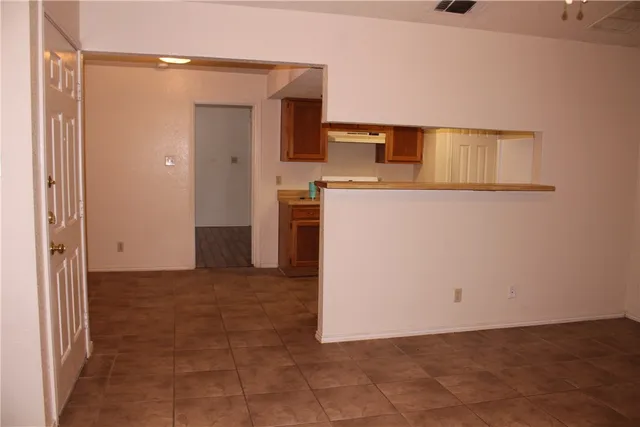 a view of a kitchen cabinets and a refrigerator