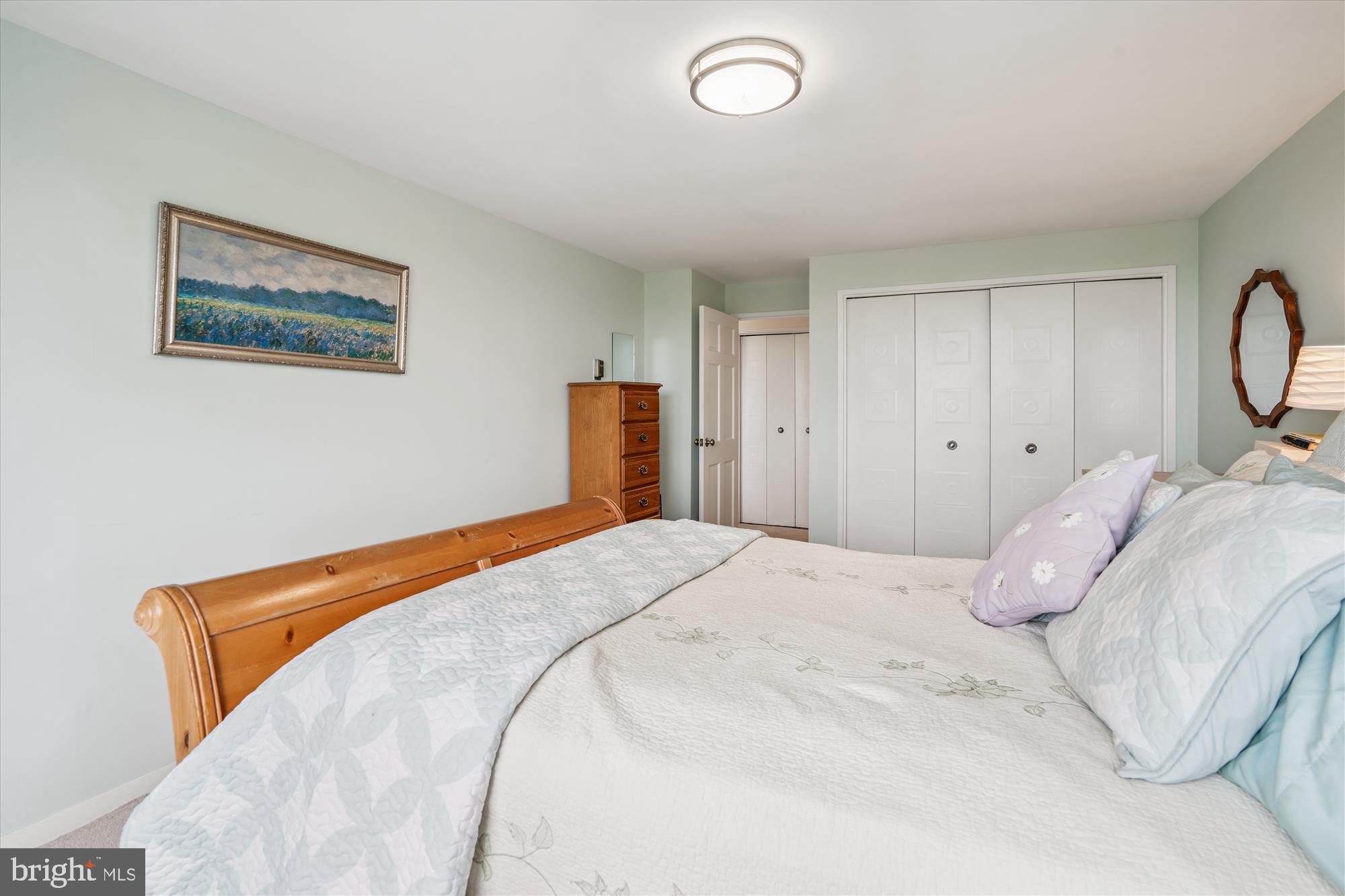 1900 Lyttonsville Road, Unit 1308 Silver Spring, MD 20910 - Photo 24 of 52 a bedroom with a bed and a painting on the wall