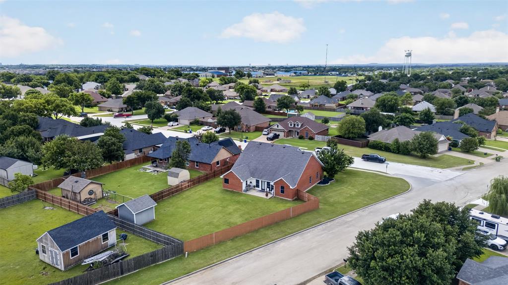 100 Radecke Road Krum, TX 76249 - Photo 5 of 29 Expansive green lawns with mature trees, fenced backyards, and multiple outbuildings