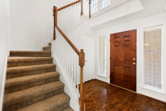 a view of entryway with stairs and wooden floor
