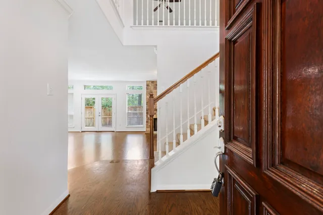 a view of an entryway with wooden floor and stairs