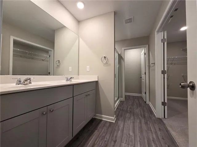 a bathroom with a double vanity sink and mirror