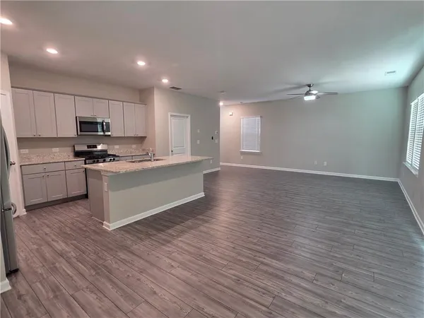 a view of kitchen with microwave and cabinets