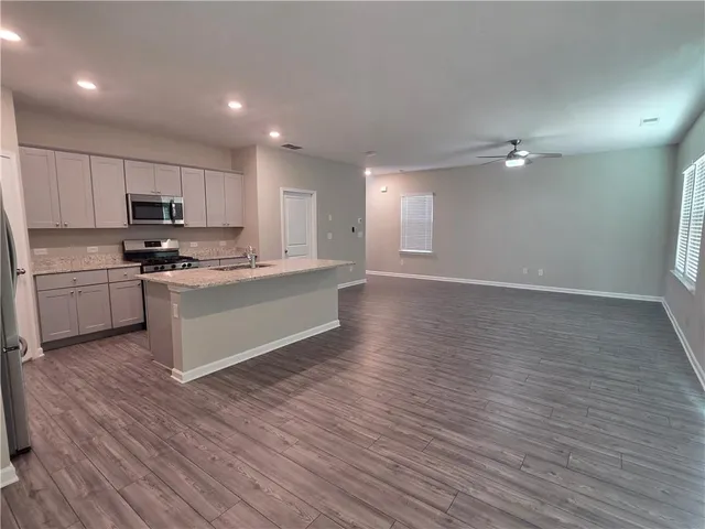 a view of kitchen with microwave and cabinets