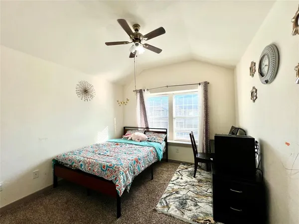 a bedroom with a bed and window