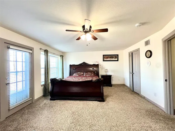 a living room with furniture a ceiling fan and a rug