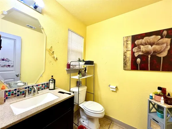 a bathroom with a sink mirror vanity and toilet