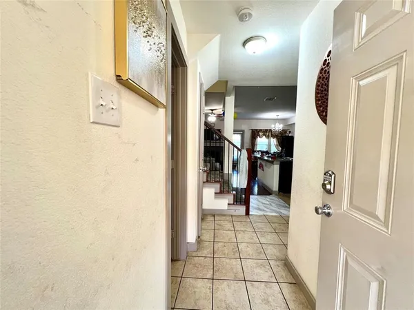 a view of a hallway and a livingroom with furniture
