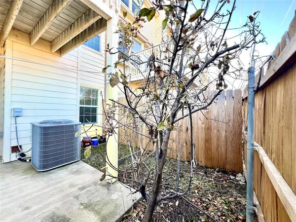 a view of yellow house next to a yard