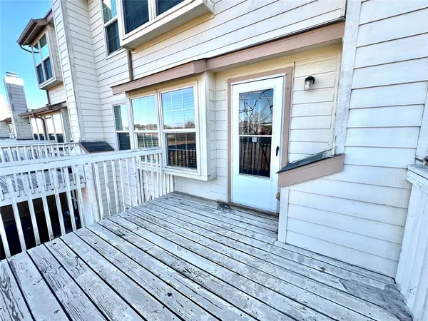 a view of a house with wooden deck