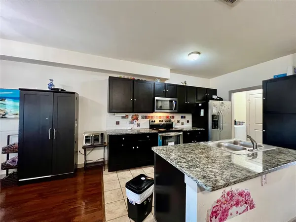 a kitchen with refrigerator and stove