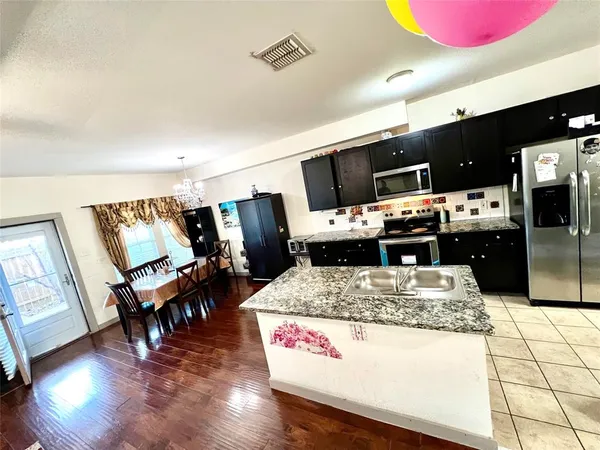 a view of kitchen with furniture and wooden floor