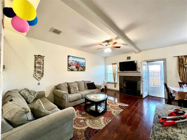 a living room with furniture kitchen view and a fireplace