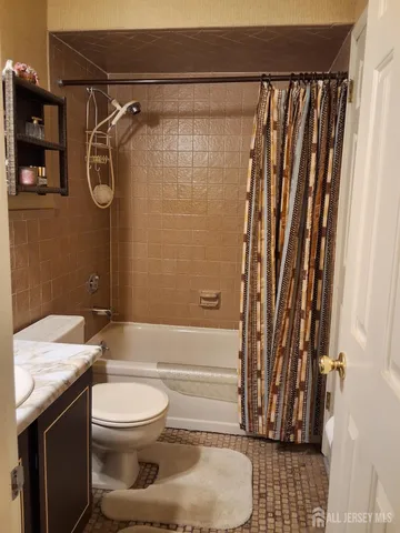 a bathroom with a toilet a sink and a shower