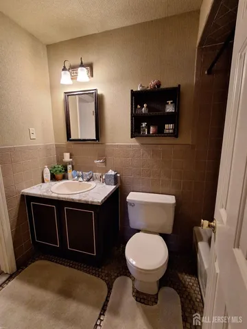 a bathroom with a toilet sink and mirror