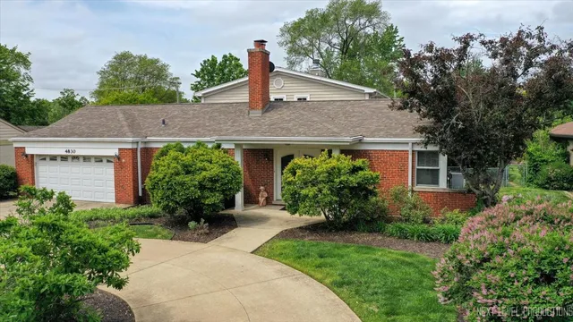 a front view of a house with a yard garage and outdoor seating