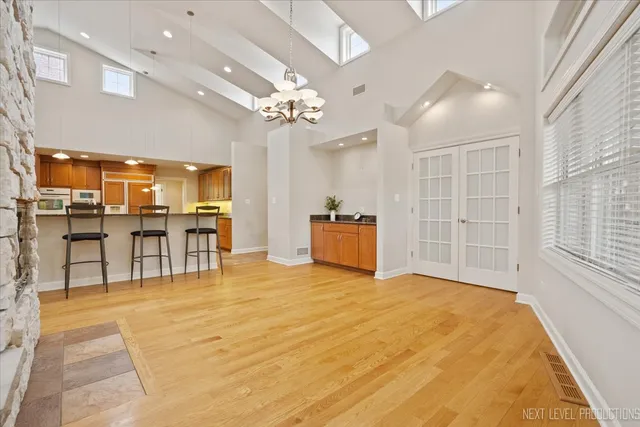 a large room with chandelier fan and windows