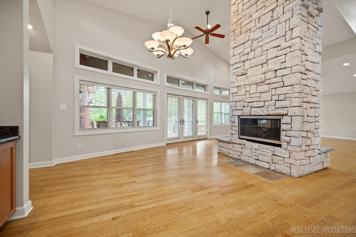 4830 Wolf Road Western Springs, IL 60558 - Photo 13 of 46 a view of an empty room with a fireplace and a chandelier