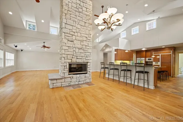 a living room with fireplace furniture and a wooden floor
