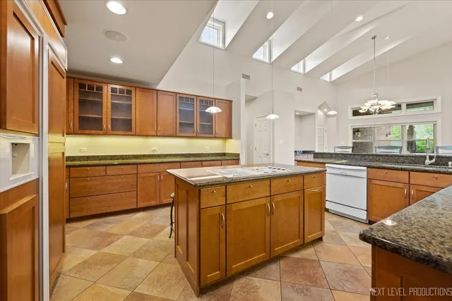 a kitchen with stainless steel appliances granite countertop a stove and a sink