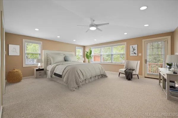a bedroom with bed and a large window