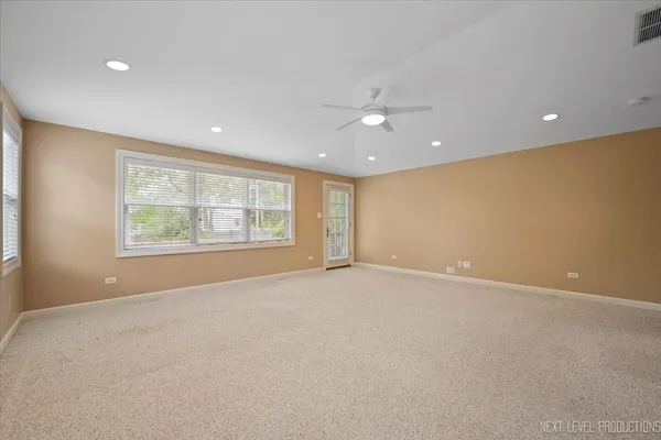 an empty room with windows and closet